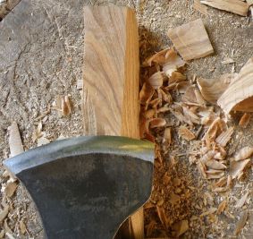Using the same axe to shave away slivers from the wood removes the evidence of the previous cuts. The small, thin shavings lie scattered on the chopping-block.