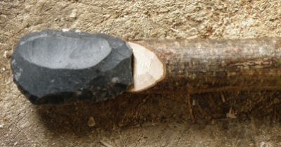 This is another example of a scraper seated on a lap at the end of the handle. The scraper was knapped from a nice flake of silicified greensand from Dorset. Space has been cut in the hazel to accommodate the shape of the flake's bulb of percussion.